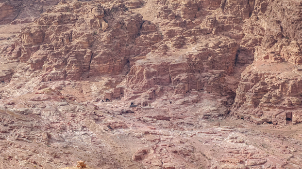 View of the ancient rock cut tombs and sandstone cliffs of the historic archaeological site in Wadi Musa Ma an Governorate Jordan. View of the ancient rock cut tombs and sandstone cliffs of the historic archaeological site in Wadi Musa Ma an Governorate Jordan.