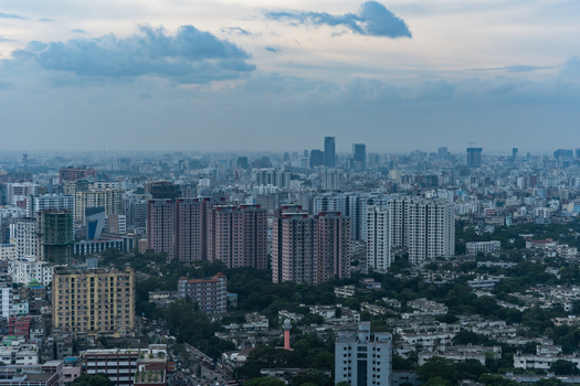 Dhaka Bangladesh 30 June 2025 Aerial view of the dense urban skyline of Dhaka featuring numerous high rise residential and commercial buildings under a cloudy sky.