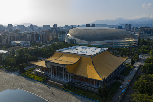Aerial view of the National Dr. Sun Yat sen Memorial Hall with its iconic yellow roof situated near the modern Taipei Dome stadium in the urban landscape of Taipei Taiwan. Aerial view of the National Dr. Sun Yat sen Memorial Hall with its iconic yellow roof situated near the modern Taipei Dome stadium in the urban landscape of Taipei Taiwan.