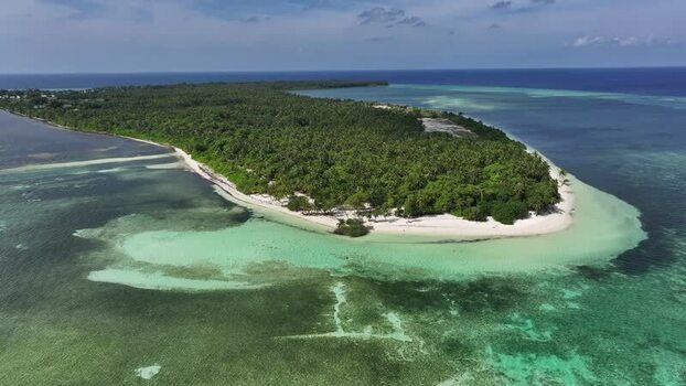 Aerial view of the lush tropical island and coral reefs Maldives. Aerial view of the lush tropical island and coral reefs Maldives.