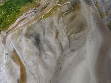 Aerial view of Abstract Tidal Patterns Culbin Sands showing intricate sand formations tidal channels and patches of green vegetation in Nairn Scotland United Kingdom. Aerial view of Abstract Tidal Patterns Culbin Sands showing intricate sand formations tidal channels and patches of green vegetation in Nairn Scotland United Kingdom.