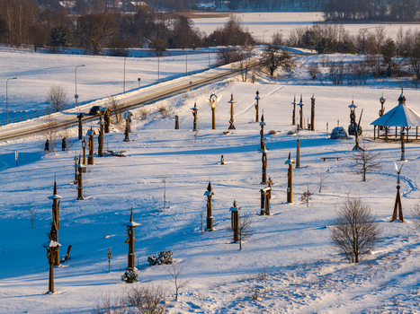 Aerial view of the Hill of Angels featuring wooden sculptures in a snow covered landscape with a road and people walking in Traku rajonas Vilniaus apskritis Lithuania. Aerial view of the Hill of Angels featuring wooden sculptures in a snow covered landscape with a road and people walking in Traku rajonas Vilniaus apskritis Lithuania.