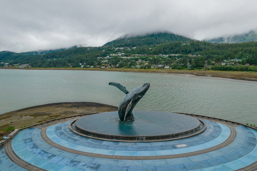 Aerial view of the Whale Project sculpture in a circular fountain with the town of Juneau and forested mountains in the background in Juneau Alaska United States. Aerial view of the Whale Project sculpture in a circular fountain with the town of Juneau and forested mountains in the background in Juneau Alaska United States.