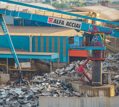 Brescia Italy 13 September 2026 Aerial view of the Alfa Acciai crane and scrap metal storage yard showing piles of recycled steel feedstock at the industrial steel plant. Brescia Italy 13 September 2026 Aerial view of the Alfa Acciai crane and scrap metal storage yard showing piles of recycled steel feedstock at the industrial steel plant.