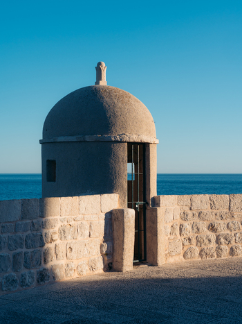 View of a historic stone watchtower on the city walls overlooking the blue Adriatic Sea in Dubrovnik Old Town Dubrovnik Dubrovnik Neretva County Croatia. View of a historic stone watchtower on the city walls overlooking the blue Adriatic Sea in Dubrovnik Old Town Dubrovnik Dubrovnik Neretva County Croatia.
