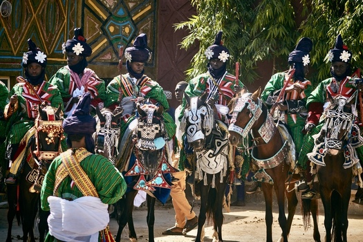 Zaria city Nigeria 21 March 2026 View of elegantly dressed horsemen in vibrant green and red robes with intricately adorned horses gathered for a cultural spectacle near Kofar Fada. Zaria city Nigeria 21 March 2026 View of elegantly dressed horsemen in vibrant green and red robes with intricately adorned horses gathered for a cultural spectacle near Kofar Fada.