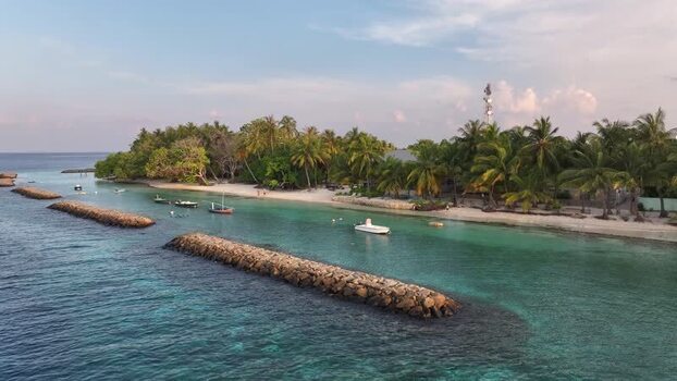 Aerial view of tropical island with palm trees in Kendhoo Maldives. Aerial view of tropical island with palm trees in Kendhoo Maldives.