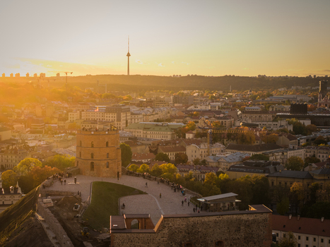 Aerial view of the Gediminas Tower standing tall against a golden sunset casting long shadows over the cityscape and Vilnius TV Tower Vilnius Lithuania. Aerial view of the Gediminas Tower standing tall against a golden sunset casting long shadows over the cityscape and Vilnius TV Tower Vilnius Lithuania.