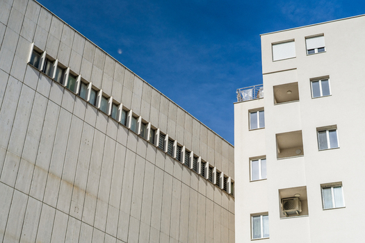 View of modern white buildings with clean architectural lines and windows under a clear blue sky in Bratislava Bratislava Region Slovakia. View of modern white buildings with clean architectural lines and windows under a clear blue sky in Bratislava Bratislava Region Slovakia.