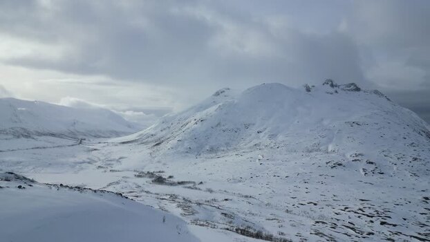 Aerial view of snow covered mountains on Kvaloya island Norway.