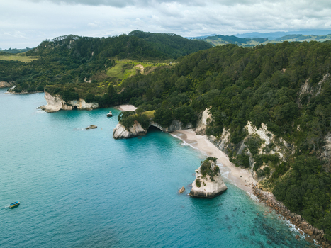 Aerial view of Cathedral Cove s iconic archway and Te Whanganui A Hei Marine Reserve where turquoise waters meet verdant cliffs Waikato Waikato Region New Zealand. Aerial view of Cathedral Cove s iconic archway and Te Whanganui A Hei Marine Reserve where turquoise waters meet verdant cliffs Waikato Waikato Region New Zealand.