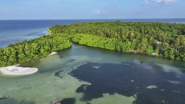 Aerial view of the lush tropical island and lagoon in Goidhoo Maldives. Aerial view of the lush tropical island and lagoon in Goidhoo Maldives.