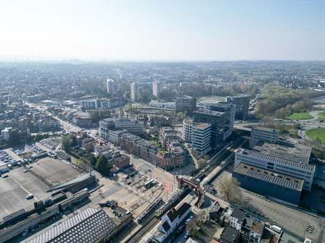 Aerial view of modern buildings and classic brick houses nestled together under a pale sky where roads and railways intertwine Ganshoren Brussels Belgium. Aerial view of modern buildings and classic brick houses nestled together under a pale sky where roads and railways intertwine Ganshoren Brussels Belgium.