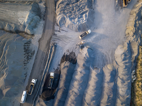 Aerial view of a gravel quarry with dump trucks transporting materials and large piles of crushed stone in Istanbul Istanbul Turkiye.