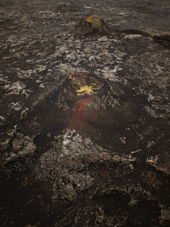Aerial view of volcanic craters and solidified lava fields with patches of moss in Reykjanesbaer Iceland.