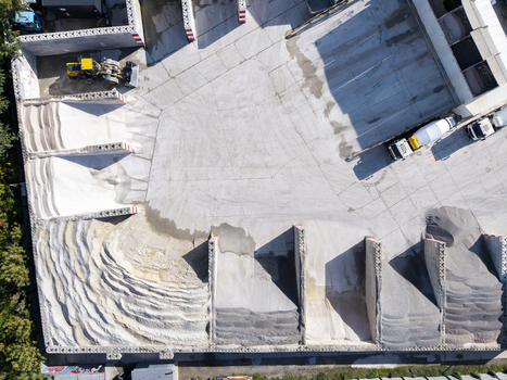 Aerial view of the Holcim concrete plant with piles of aggregate a front loader and concrete mixer trucks on the yard in Krakow Lesser Poland Voivode Poland.