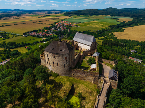 Aerial view of Tocnik Castle surrounded by lush green forests and rolling fields in Tocnik Stredocesky kraj Czechia. Aerial view of Tocnik Castle surrounded by lush green forests and rolling fields in Tocnik Stredocesky kraj Czechia.
