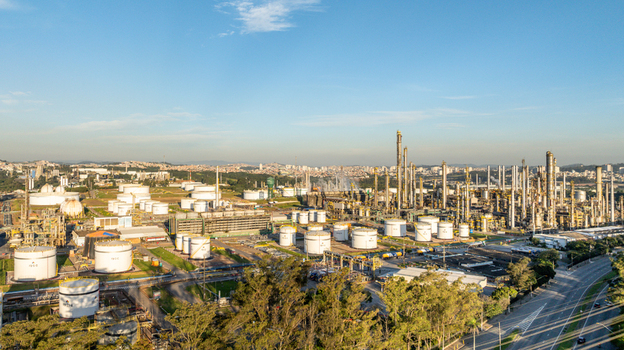 Aerial view of a large petrochemical complex with storage tanks processing towers and industrial infrastructure situated in an urban landscape in Santo Andre State of Sao Paulo Brazil.
