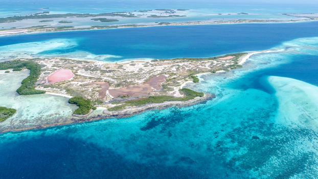 Aerial view of Los Roques archipelago featuring turquoise waters coral reefs and sandy beaches in Los Roques Dependencias Federale Venezuela. Aerial view of Los Roques archipelago featuring turquoise waters coral reefs and sandy beaches in Los Roques Dependencias Federale Venezuela.