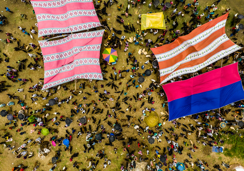 Aerial view of Baish Mowza Sarak Bazar with colorful tents and crowds of people gathering at the busy livestock market in Nabinagar Chittagong Division Bangladesh. Aerial view of Baish Mowza Sarak Bazar with colorful tents and crowds of people gathering at the busy livestock market in Nabinagar Chittagong Division Bangladesh.