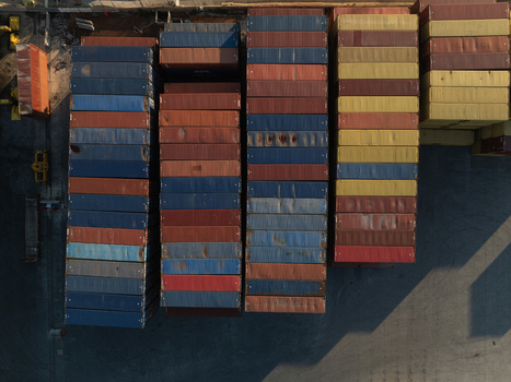 Aerial view of stacked multi colored shipping containers in a commercial port during sunset Augusta Sicily Italy. Aerial view of stacked multi colored shipping containers in a commercial port during sunset Augusta Sicily Italy.