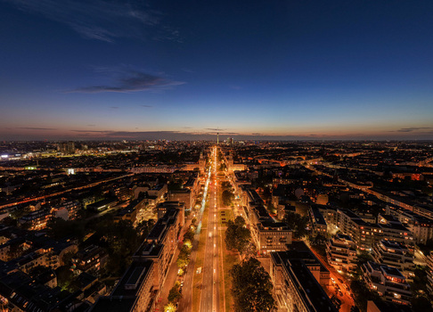 Aerial view of the Berlin skyline at night featuring the illuminated Frankfurter Allee stretching into the distance under a twilight sky in Berlin Berlin Germany. Aerial view of the Berlin skyline at night featuring the illuminated Frankfurter Allee stretching into the distance under a twilight sky in Berlin Berlin Germany.