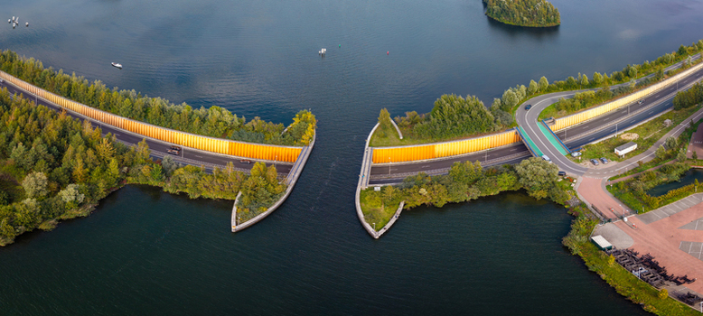 Aerial view of Aquaduct Veluwemeer a unique water bridge where the road passes under the lake surrounded by lush greenery in Harderwijk Gelderland Netherlands.