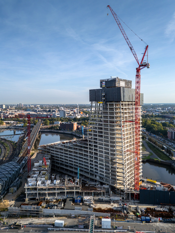 Hamburg Germany 28 September 2026 Aerial view of Elbtower under construction with tall red cranes concrete framework and surrounding urban infrastructure. Hamburg Germany 28 September 2026 Aerial view of Elbtower under construction with tall red cranes concrete framework and surrounding urban infrastructure.