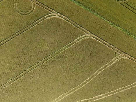 Aerial view of agricultural fields with tractor tracks and patterns in the landscape in Greyton Western Cape South Africa.