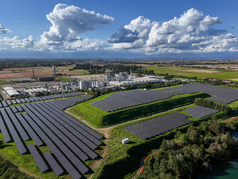 Aerial view of a large solar panel farm and industrial facility under a dramatic cloudy sky in Crescentino Piedmont Italy. Aerial view of a large solar panel farm and industrial facility under a dramatic cloudy sky in Crescentino Piedmont Italy.