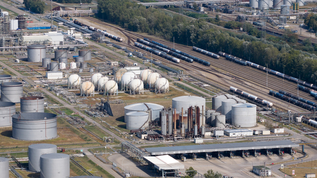 Aerial view of Mineralolraffinerie Oberrhein industrial complex with large storage tanks processing units and railway tracks for freight transport in Karlsruhe Baden Wurttemberg Germany. Aerial view of Mineralolraffinerie Oberrhein industrial complex with large storage tanks processing units and railway tracks for freight transport in Karlsruhe Baden Wurttemberg Germany.
