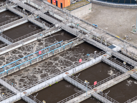 Aerial view of Klarwerk Ruhleben wastewater treatment plant with aeration tanks industrial infrastructure and concrete walkways in Berlin Berlin Germany.