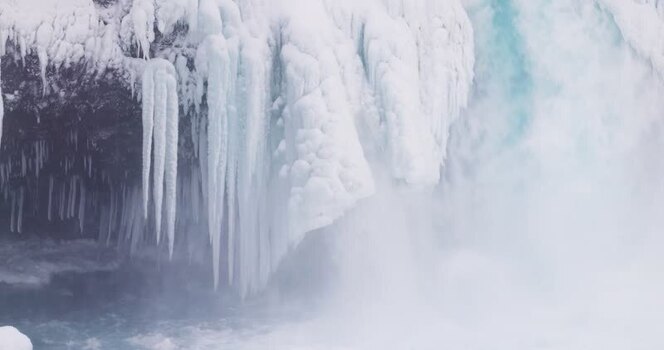 View of frozen waterfall with icicles in Iceland.