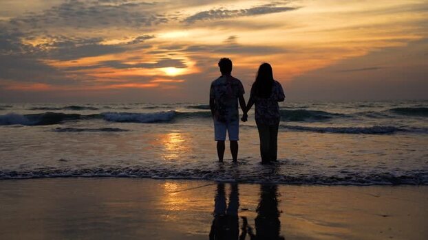 View of a couple holding hands at sunset on the beach Bangladesh. View of a couple holding hands at sunset on the beach Bangladesh.