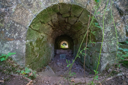 View of the historic stone tunnel and ruins of the former china clay works in the Tregargus Valley Cornwall United Kingdom. View of the historic stone tunnel and ruins of the former china clay works in the Tregargus Valley Cornwall United Kingdom.