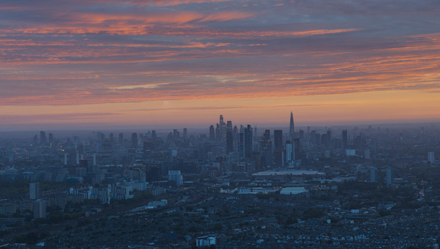 Aerial view of the London skyline at sunset with vibrant orange and pink clouds over the city featuring iconic skyscrapers and urban architecture in Wandsworth London United Kingdom.