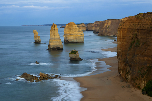 View of the Twelve Apostles Marine National Park limestone stacks standing in the Southern Ocean along the rugged cliffs and sandy beach Australia. View of the Twelve Apostles Marine National Park limestone stacks standing in the Southern Ocean along the rugged cliffs and sandy beach Australia.
