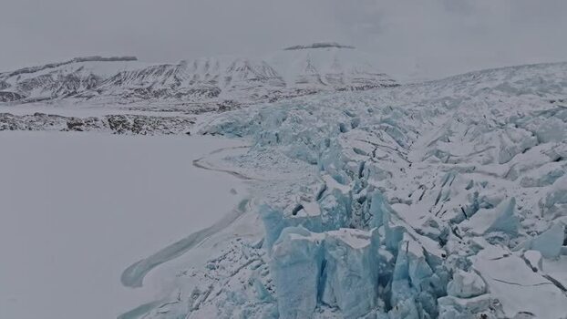 Aerial view of glacier with blue crevasses Svalbard and Jan Mayen.