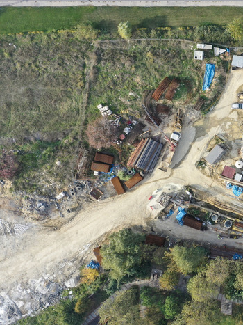 Aerial view of a construction site with stacks of metal pipes and industrial materials on dirt ground surrounded by trees in Avcilar Istanbul Turkiye. Aerial view of a construction site with stacks of metal pipes and industrial materials on dirt ground surrounded by trees in Avcilar Istanbul Turkiye.
