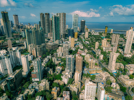 Mumbai India 17 May 2026 Aerial view of the dense Mumbai skyline featuring modern skyscrapers residential towers and lush greenery under a clear blue sky. Mumbai India 17 May 2026 Aerial view of the dense Mumbai skyline featuring modern skyscrapers residential towers and lush greenery under a clear blue sky.