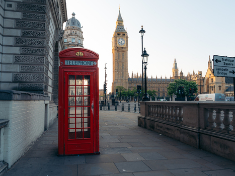 London United Kingdom 19 June 2025 View of a vibrant red telephone booth stands in stark contrast to the muted tones of Big Ben and the Houses of Parliament in the distance. London United Kingdom 19 June 2025 View of a vibrant red telephone booth stands in stark contrast to the muted tones of Big Ben and the Houses of Parliament in the distance.