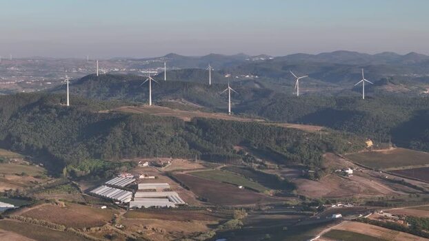 Aerial view of wind farm on rolling hills in Portugal. Aerial view of wind farm on rolling hills in Portugal.