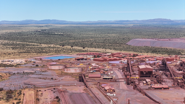 Aerial view of a sprawling industrial mining complex with vast reddish brown earthworks and processing facilities amidst green bushveld Rustenburg North West South Africa. Aerial view of a sprawling industrial mining complex with vast reddish brown earthworks and processing facilities amidst green bushveld Rustenburg North West South Africa.
