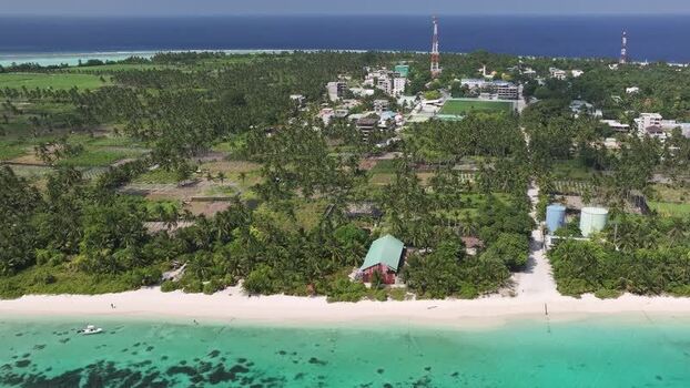 Aerial view of the tropical island of Thoddoo with palm trees Maldives. Aerial view of the tropical island of Thoddoo with palm trees Maldives.