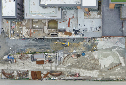 Aerial view of an active construction site featuring excavators building foundations and stacks of construction materials Sariyer Istanbul Turkiye. Aerial view of an active construction site featuring excavators building foundations and stacks of construction materials Sariyer Istanbul Turkiye.