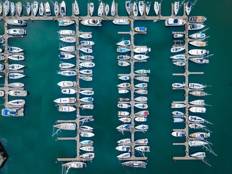 Aerial view of Bangor Harbour and Town with numerous sailboats and yachts moored in orderly rows along floating piers in the marina in Bangor Northern Ireland United Kingdom.