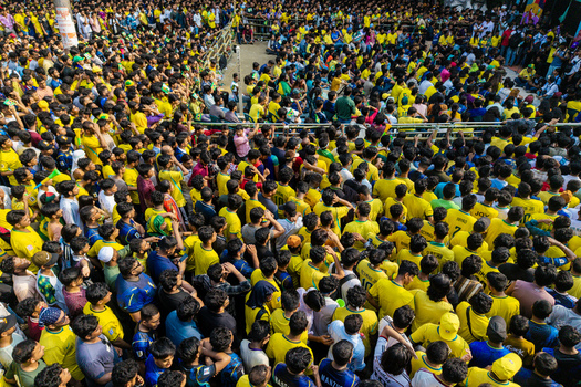 Dhaka Bangladesh 20 June 2026 Aerial view of a large crowd of football fans in yellow jerseys gathered at Dhaka University Campus with people standing closely in an urban space. Dhaka Bangladesh 20 June 2026 Aerial view of a large crowd of football fans in yellow jerseys gathered at Dhaka University Campus with people standing closely in an urban space.