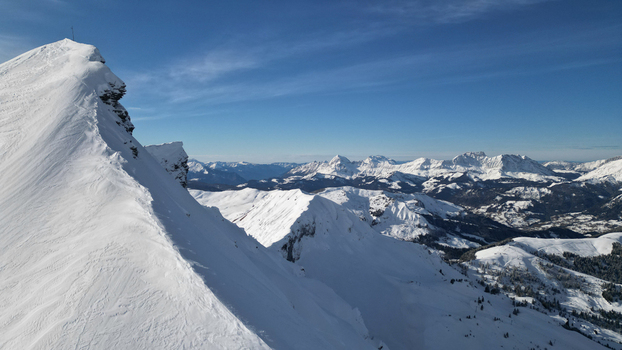 Aerial view of the snow covered Aiguille Croche peak and the alpine mountain range under a clear blue sky in Les Contamines Montjoie Auvergne Rhone Alpes France. Aerial view of the snow covered Aiguille Croche peak and the alpine mountain range under a clear blue sky in Les Contamines Montjoie Auvergne Rhone Alpes France.