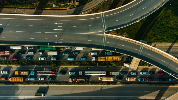 Aerial view of the Pokuase Interchange featuring multi level highway ramps with heavy traffic and trucks moving through the urban landscape in Ga North Municipal Greater Accra Region Ghana. Aerial view of the Pokuase Interchange featuring multi level highway ramps with heavy traffic and trucks moving through the urban landscape in Ga North Municipal Greater Accra Region Ghana.