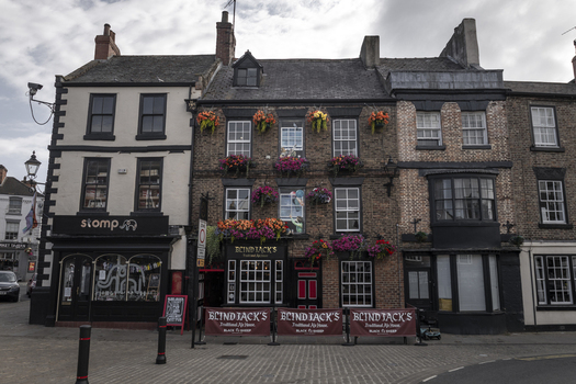Knaresborough United Kingdom 14 July 2026 View of Blind Jack s pub with its historic brick facade vibrant hanging flower baskets and traditional signage in the town center.